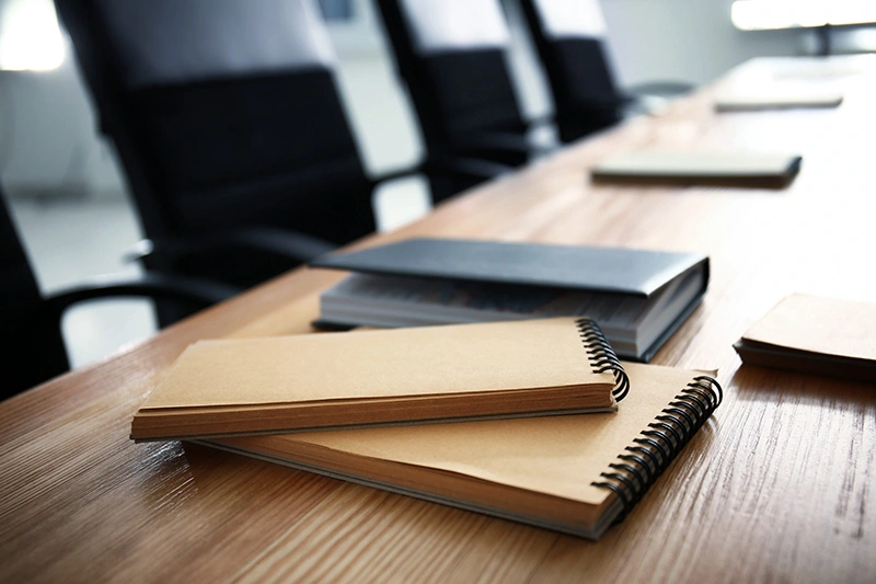 notebooks on a table in a boardroom