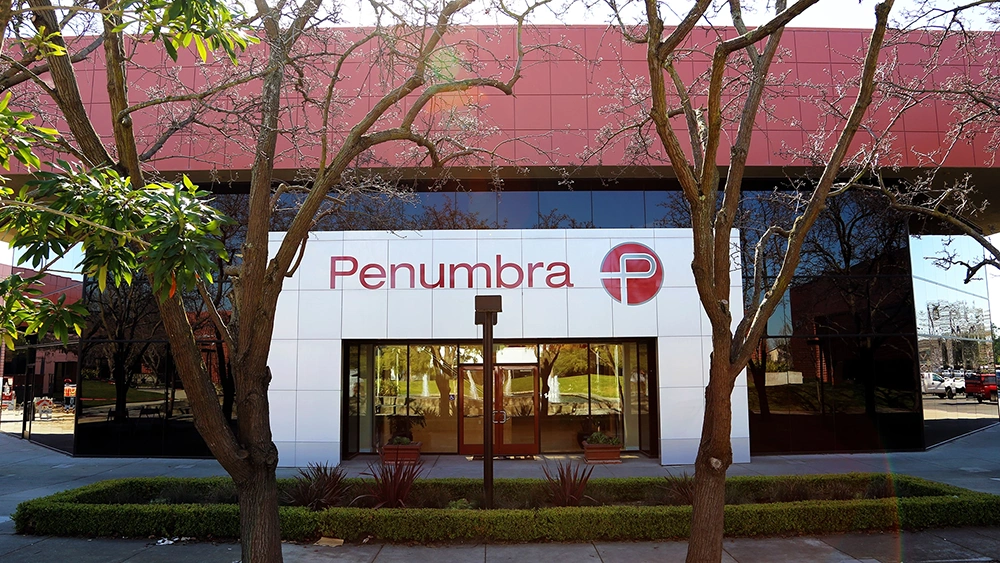 front of another building at the Penumbra Campus with Penumbra P logo outdoors