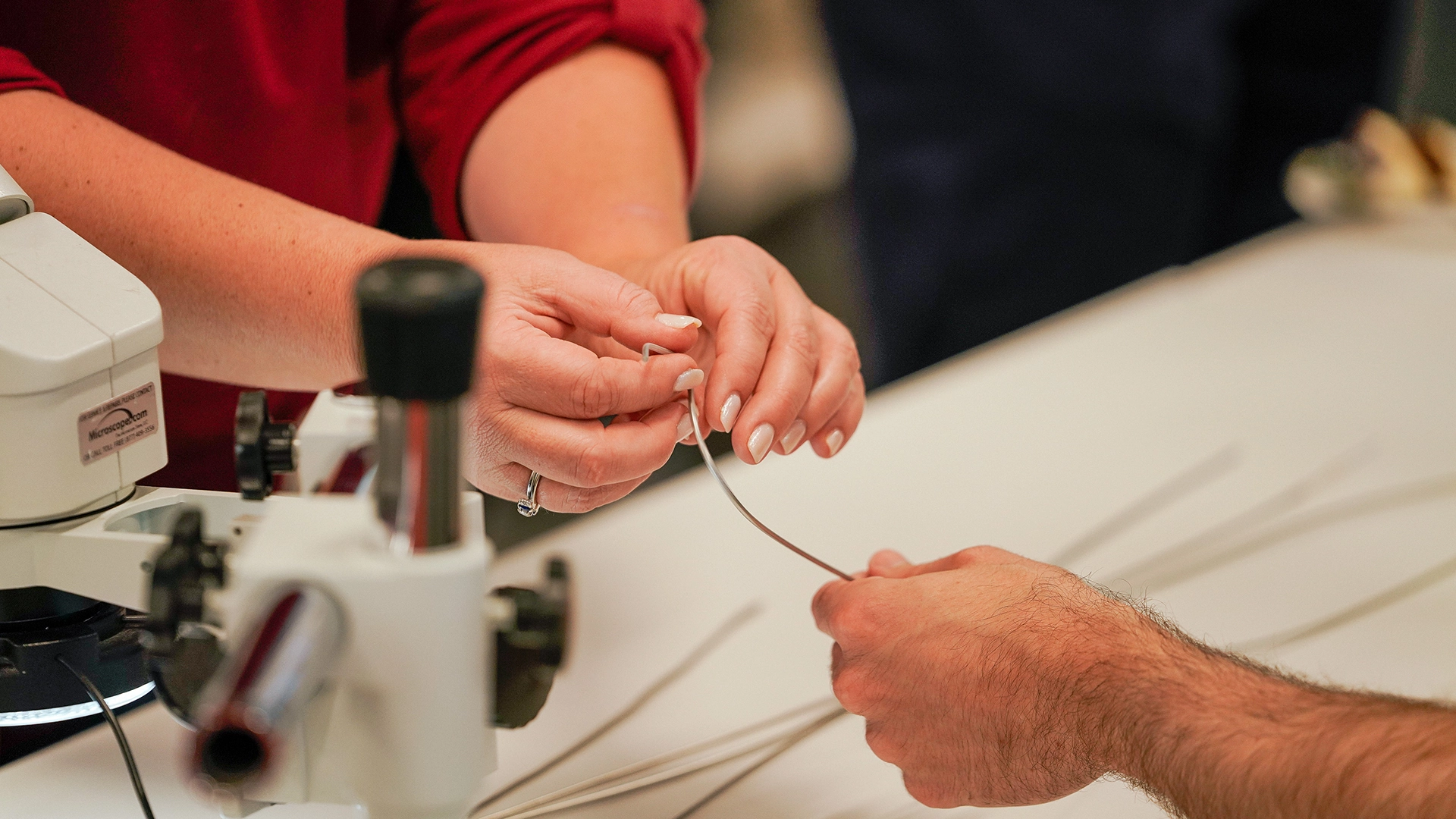 Hands of people engineering a catheter