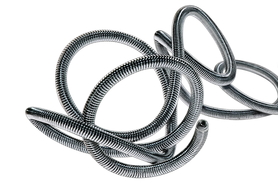 Close-up of multiple ruby embolization coils intertwined, showing textured helical structure against…