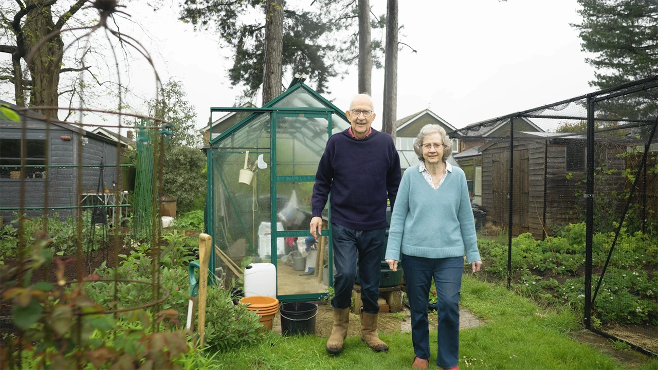 Man and woman walking in garden