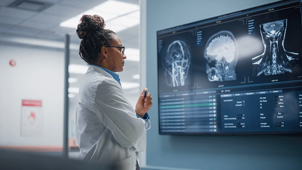 female physician reviewing images of a patient's head and brain in the hospital