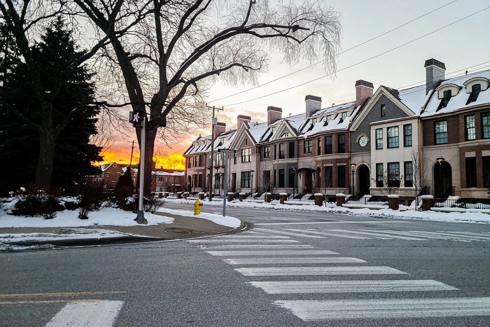 Sunset in the winter in downtown Birmingham, Michigan with townhomes in the foreground